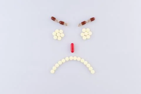 Tablets in the form of sad faces Foto stock