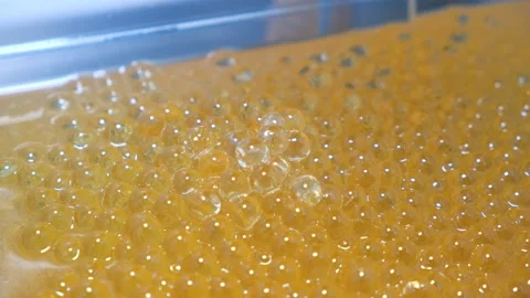 Tablets in a gelatinous shell close-up. Production of medicinal products Stock Footage 171934112