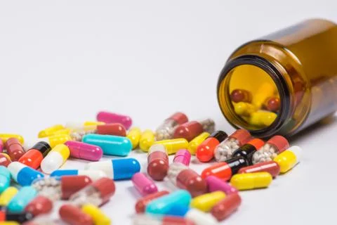 Tablets  in the glass bottle on a white background Stock Photos