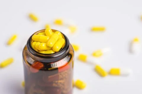 Tablets  in the glass bottle on a white background Stock Photos