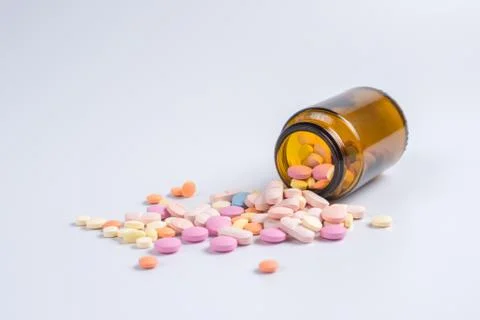 Tablets in the glass bottle on a white background Stock Photos