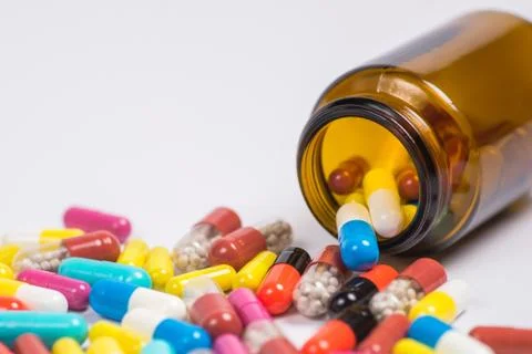 Tablets  in the glass bottle on a white background Stock Photos