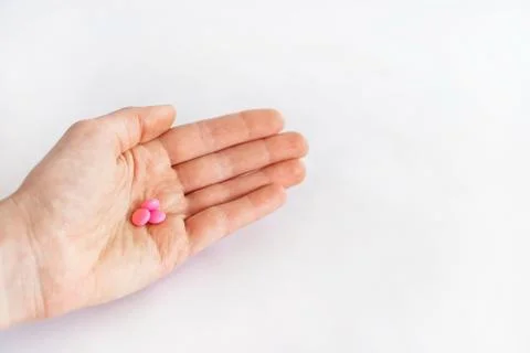 Tablets in hand on a white background close-up. Foto stock