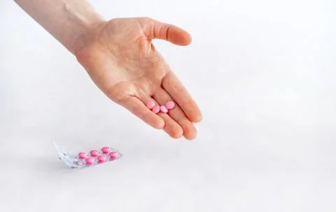 Tablets in hand on a white background close-up. Foto stock