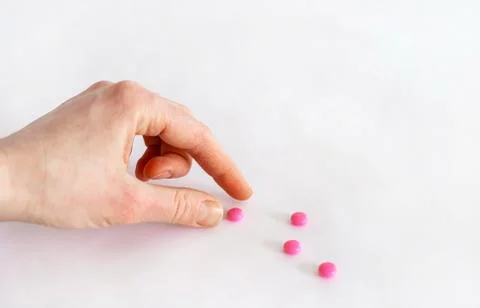 Tablets in hand on a white background close-up. Stock Photos