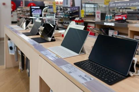 Tablets with keyboard cases on display at a Russian electronics store. Stock Photos