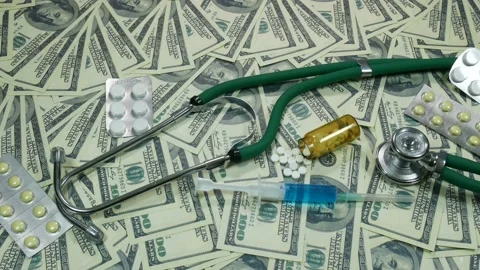 Tablets with money and stethoscope Video stock 89539581