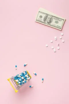 Tablets with money on a pink table. Stock Photos