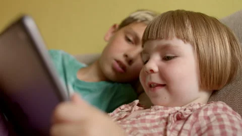 Tablets offer a wide range of entertainment content - games, movies and music Stock Footage 280127762