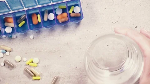 Tablets in the organizer and on the table and a glass of water in your hand top Stock Footage 93035816