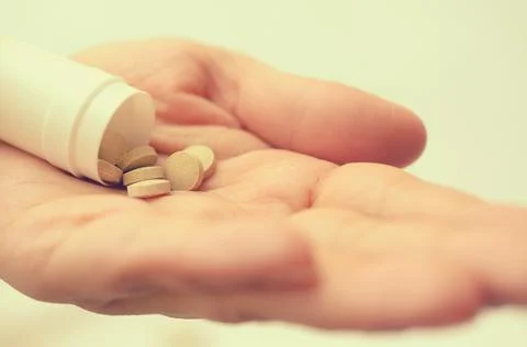 Tablets with a package in the palm of a close-up. Stock Photos
