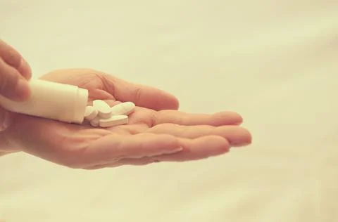 Tablets with a package in the palm of a close-up. Stock Photos