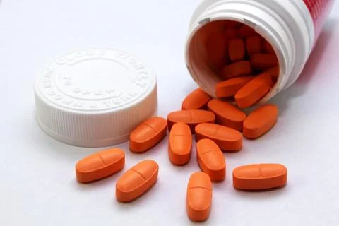 Tablets pills round out of container Stock Photos