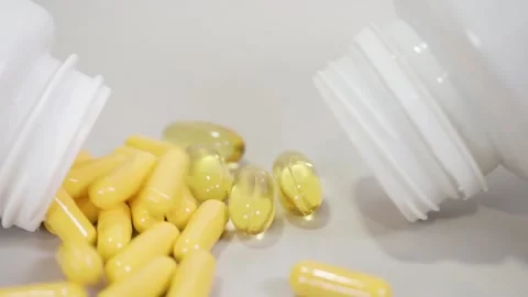 Tablets pills spilling from plastic pill bottle on natural background Video stock 267517500