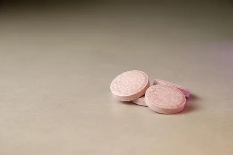 Tablets resting on a smooth surface under soft lighting in a tranquil setting Stock Photos