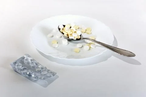 Tablets in a  spoonful Foto stock