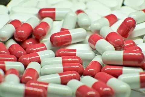 Tablets . white-red tablets. close-up . the concept of health, treatment. Stock Photos