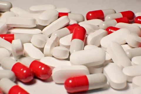 Tablets . white-red tablets. close-up . the concept of health, treatment. Stock-Fotos