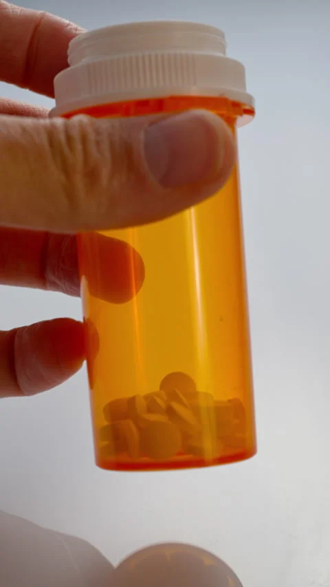 Tablets in a yellow bottle, meds in a box. Stock Footage 309573844