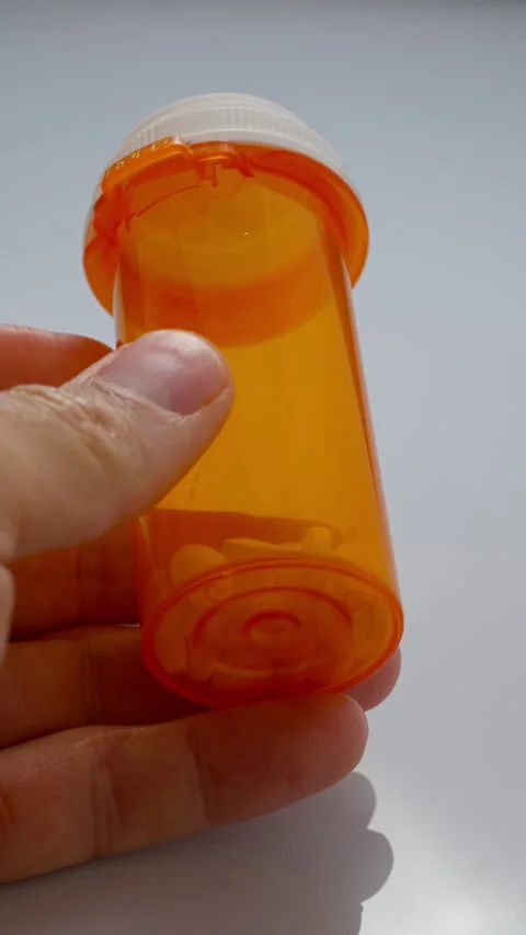 Tablets in a yellow bottle, meds in a box. Stock Footage 309574246