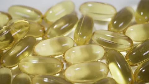 Tablets, yellow capsules on natural background. Pills for heart and vascular Video stock 267517547