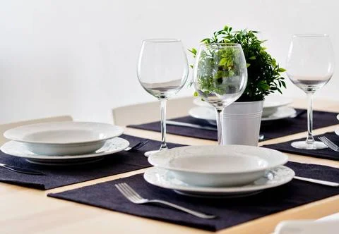Tableware and empty wine glasses ready for dinner Close up new white porce... Stock Photos