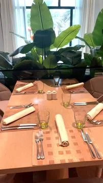 Tableware and glasses elegantly arranged on restaurant table, complemented by Stock Photos