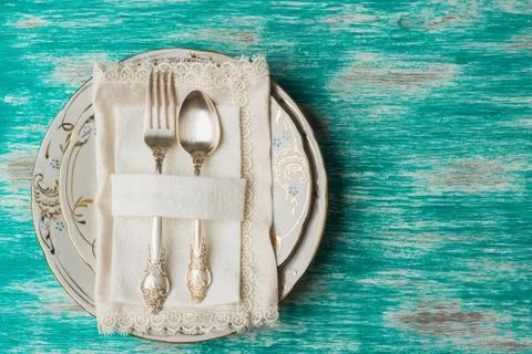 Tableware and silverware on the light blue background 库存照片
