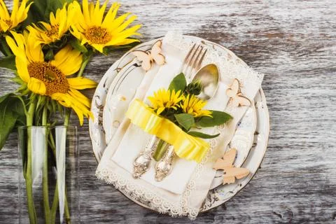 Tableware and silverware with sunflowers 스톡 사진