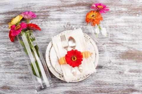 Tableware and silverware with zinnia Stock Photos
