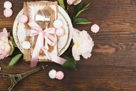 Tableware with light pink peonies and meringues Stock Photos