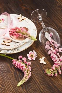 Tableware with pink lupines and silverware Stock Photos