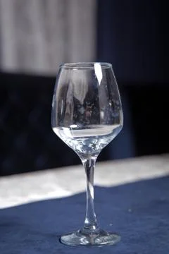 Tableware on table in cafe, focus on wineglass stem . Elegant table setting . Stock Photos