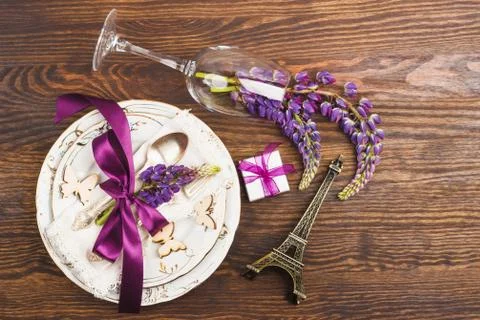 Tableware with violet lupinus and silverware Stock Photos