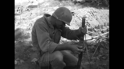 TABU-DONG - 1950 - A 27th Regiment 25th Division soldier repairs a BURP gun, and Stock Footage 280165492
