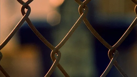 Tackling dummy seen through wiremesh fence Stock Footage 113277148