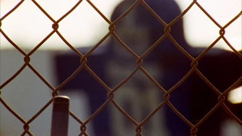 Tackling dummy seen through wiremesh fence Stock Footage 113277217