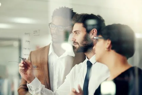 Tackling problem solving as a team. a group of businesspeople brainstorming on a Foto stock