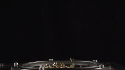 Tacks dancing in a speaker in slow motion in front of a black screen Stock Footage 81821973