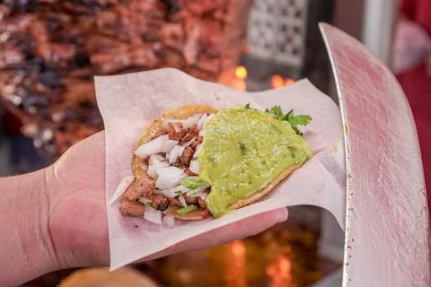 Taco de adobada held by one hand Stock Photos