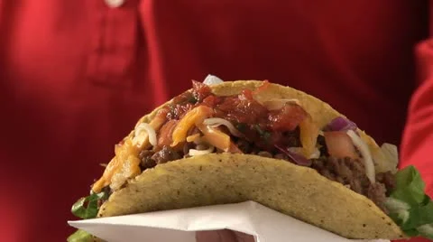 Taco shell filled with mince and salsa Stock Footage 24634252