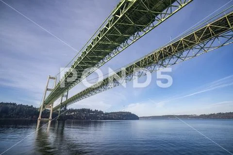 The Tacoma Narrows Bridges from the water surface, looking Northwest toward Poin Stock Photos