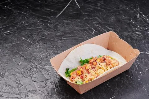 Tacos with meat, corn, cheese and lettuce in a craft container on an isolated Stock Photos