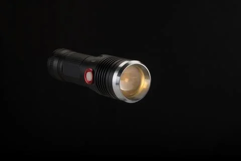 Tactical flashlight on a black background Stock Photos