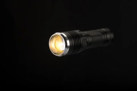 Tactical flashlight on a black background Stock Photos