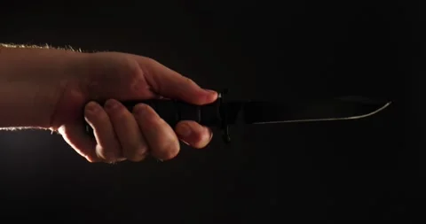 Tactical knife being thrust forward criminal concept isolated on black Vidéo 205957325