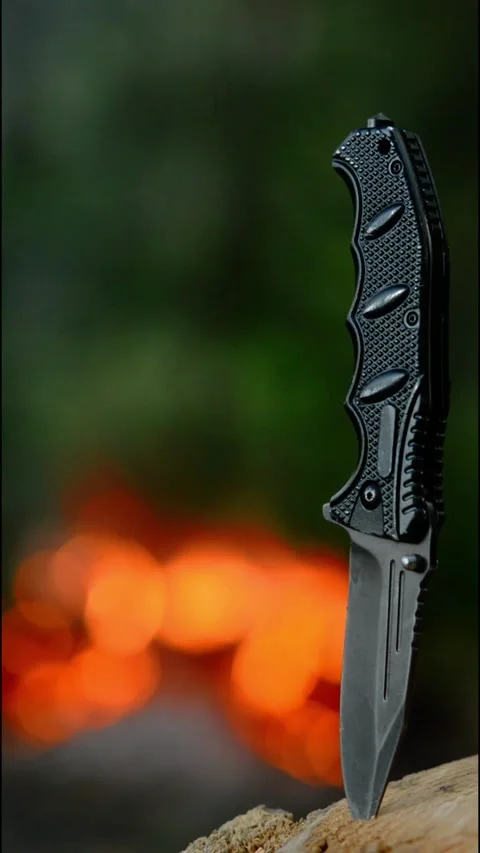Tactical Knife with Campfire Bokeh Background Stock-Footage 342120516