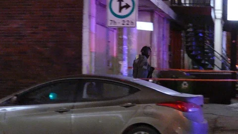 Tactical officer back facing camera and walking away and into a crime scene Stock Footage 100178208