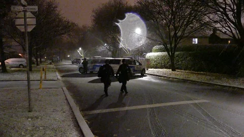 Tactical paramedics passing right by camera at night after crime incident Video stock 99010910