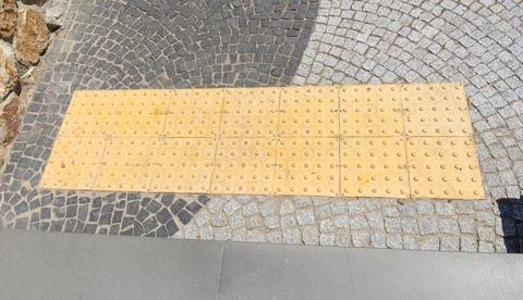 A tactile guidance path designed for visually impaired people is placed on a  Stock Photos